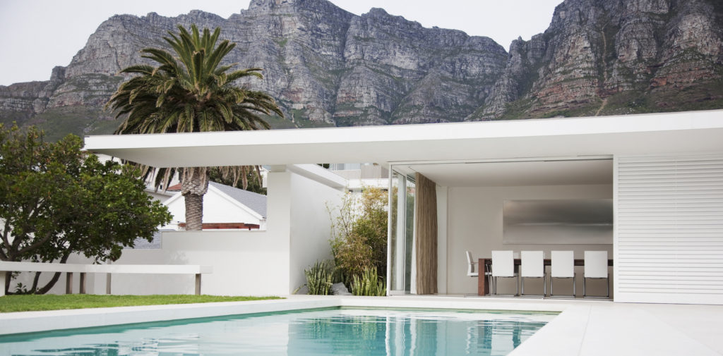 Modern dining area next to swimming pool